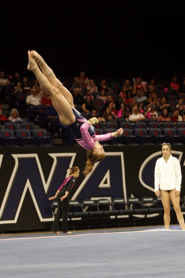 Arizona gymnastics senior Jessie Sisler soars during her floor routine on Saturday, February 27 in McKale Center. Sisler earned a 9.85 on floor in this years Pac-12 Championships after winning the event last season.

