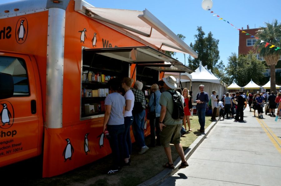 Rebecca Noble/ The Daily Wildcat

Festival-goers browse the Penguin Book Trucks selection at the Festival of Books on the UA Mall on Saturday, March 15th.  Penguin Books sends their hot dog cart inspired book trucks around the country to a variety of book related events.