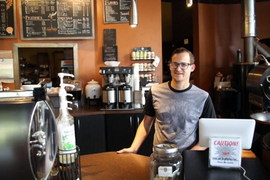 Caffe Luce manager, Clinton Baker, standing behind the counter to take coffee orders from customers on Wednesday, March 30. The coffee shop is located just north of University Boulevard on Park Avenue.