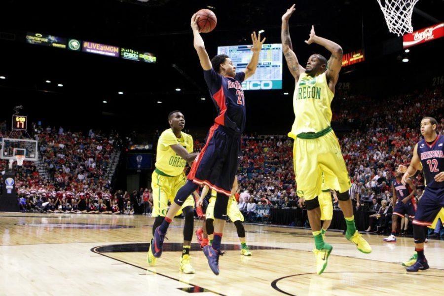Arizona center Chance Comanche attempts to dunk past an Oregon defender during the Pac-12 tournament on Friday, March 11.