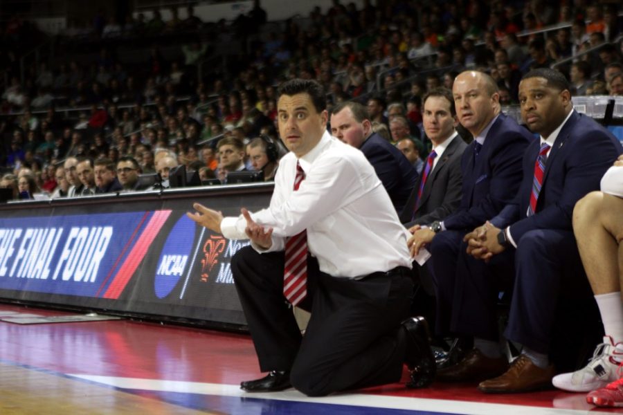 Sean Miller eyes his players with confusion during Arizonas 65-55 loss to Wichita State in the NCAA Tournament on March 17, 2016. Assistant coach Mark Phelps (left) and former assistant coach Emanuel Book Richardson sit on the bench in the background.