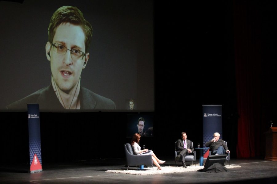 Glenn Greenwald and Noam Chomsky sit and talk with Edward Snowden over the Internet in front of a crowd at an event hosted by the College of Social and Behavioral Sciences on March 25. Members of the panel voiced their concerns about putting personal privacy at risk in the name of security.