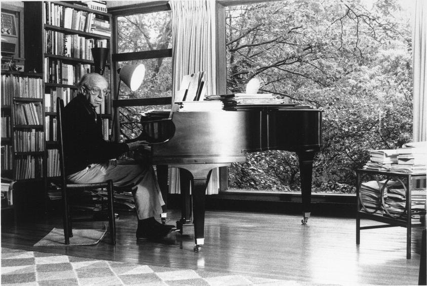 Aaron Copland at the piano in his studio.