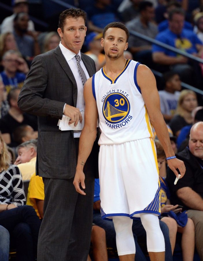 The Golden State Warriors Stephen Curry (30) confers with interim head coach Luke Walton against the Denver Nuggets in the first half of a preseason game at Oracle Arena in Oakland, Calif., on Tuesday, Oct. 13, 2015. 