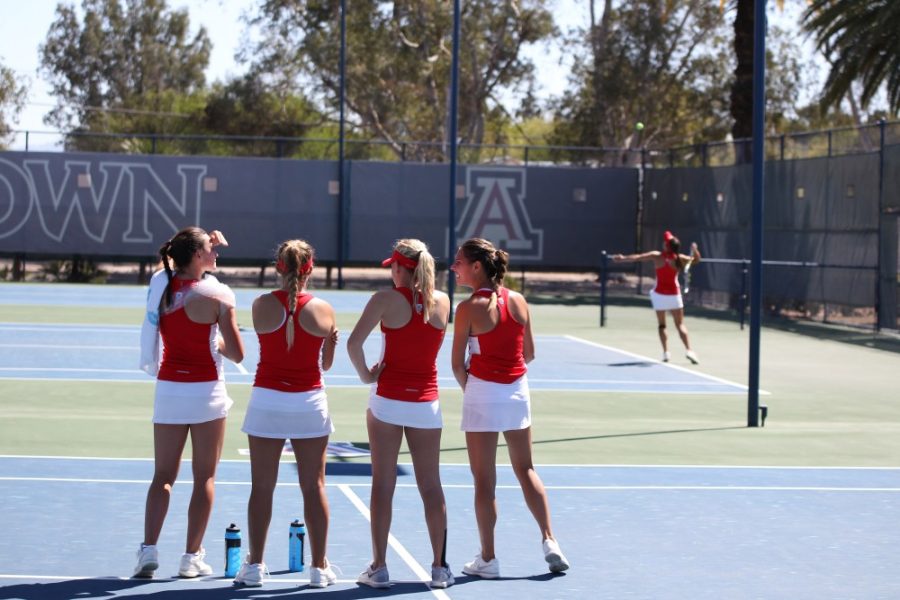 Arizona tennis players watch and encourage a teammate during a meet against Sacramento State on Saturday, March 26. The Wildcats have a tough battle on the road, matching up against USC and UCLA.