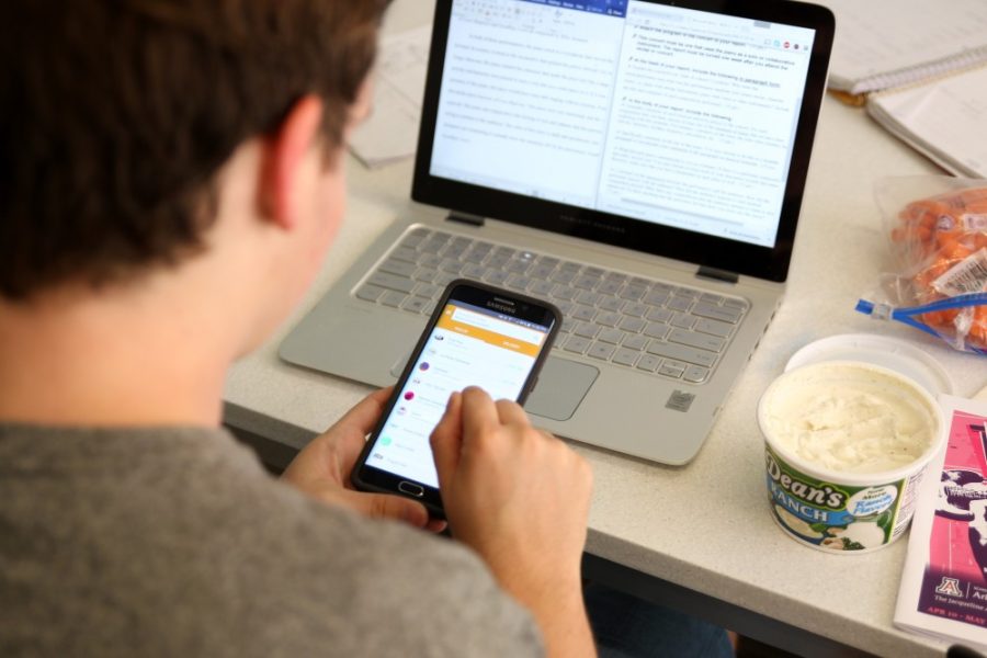Spencer Williams, freshman MCB and Microbiology major, checking out what to order on Tapingo while writing a paper on May 2nd.
