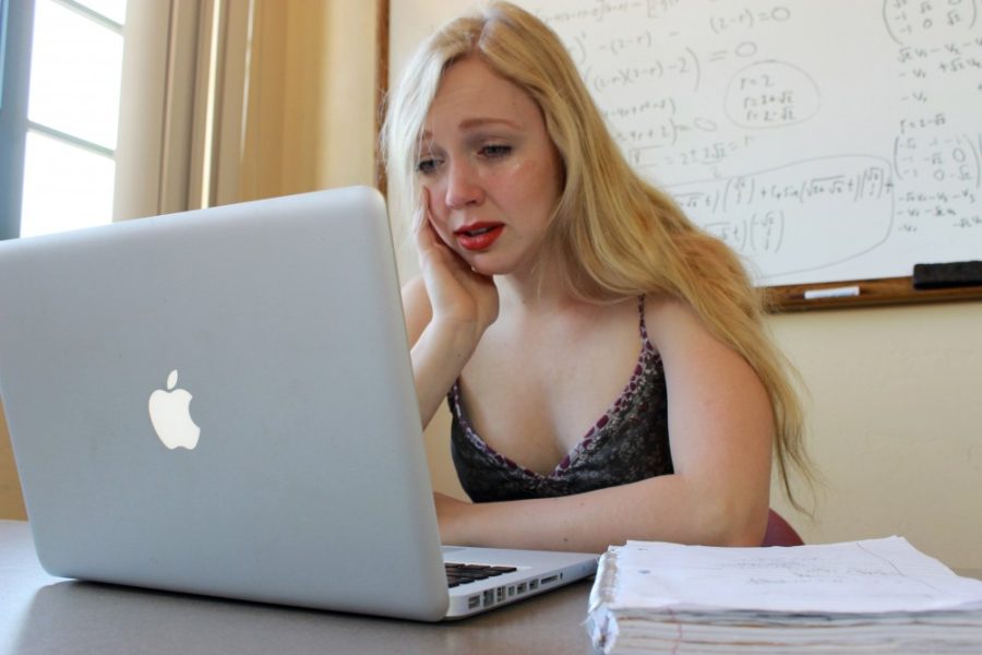 Michaela Harrington, a Dance and Neuroscience freshman, cries in a library study room while studying for finals. 