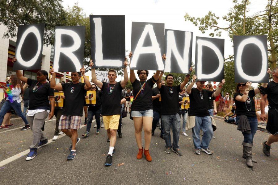 Marchers hold letters that spell out Orlando in support of the victims of Sunday's mass shooting during the annual Gay Pride parade in West Hollywood on Sunday, June 12, 2016. (Genaro Molina/Los Angeles Times/TNS)