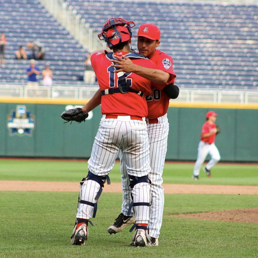 Arizona outfielder Alfonso Rivas III (20) and catcher Cesar Salazar hug after the Wildcats 5-1 victory over Oklahoma State on Saturday, June 25, 2016 in Omaha, Nebraska. Rivas recorded the final out of the game, leading Arizona into the College World Series championship series.  
