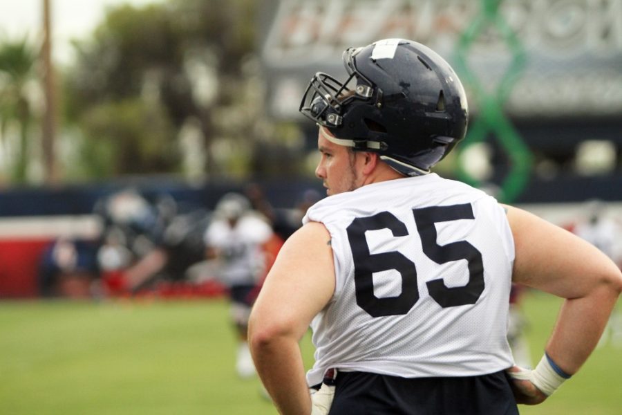 Arizona offensive lineman Zach Hemmila rests at football practice on Friday, Aug. 5. Coach Rich Rodriguez announced Hemmilas death on Monday, Aug. 8 after the teams morning practice.
