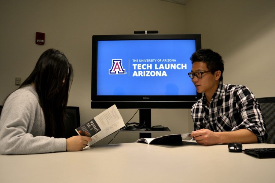 Geography and Geoscience Freshman Manny Lin and Pre-Business Freshman Linjie Liu read about Tech Launch Arizona, while visiting the building on Monday, Nov. 30, 2015.