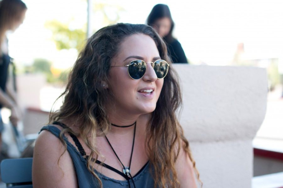 Samara Rosenthal, creator and owner of Outcharmed, answers questions on University Blvd. on Thursday, Sept. 15. Rosenthal is currently a sophomore Majoring in Retail and minoring in communications, with dreams of starting her own clothing line.
