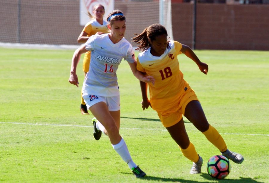Arizona midfielder Jaden DeGracie-Bailey (14) attempts to get the ball from USC defender Kayla Mills (18) in Fridays game at USC. Arizona lost 0-4. This was the opening game of conference play and takes Arizonas record to 5-3-1.