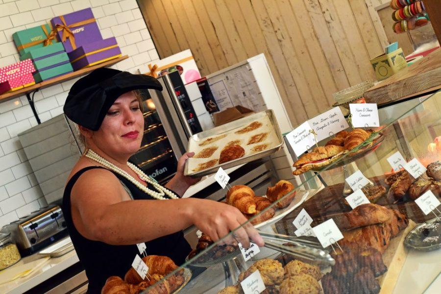 Care, health and society major Ashley Raujol delicately sets out fresh pastries at Woops! bakery on University Boulevard on Tuesday, Sept. 13, 2016. Woops! opened in the last week of August of 2016 and Raujol has worked here ever since. Raujol, loves baking, has been cooking all [her] life and loves the owners vision, describing the bakery as a tranquil, happy environment. When Roujol heard about the job opening, she thought to herself that it would be, the best job ever, and has been baking and cashiering ever since.