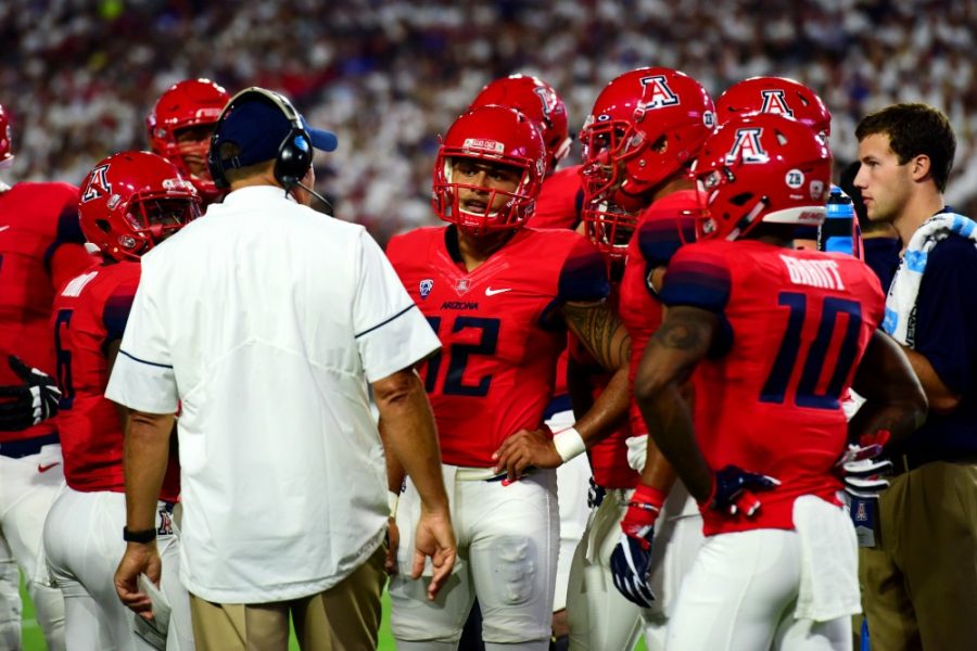 Arizona quarterback Anu Solomon (12) huddles with head coach Rich Rodriguez and the offense in the Wildcats 18-16 Cactus Kickoff Classic loss to BYU at the University of Phoenix Stadium on Saturday, Sept. 3. Solomon struggled and put the loss on his shoulders following the game.