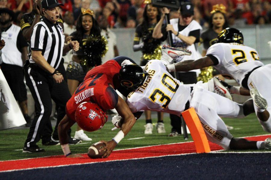Arizona quarterback Brandon Dawkins (13) scores the first touchdown in the game against Grambling State on Saturday. This was the first of three total touchdowns for Dawkins.