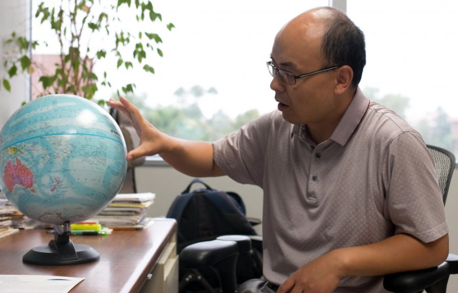 Associate Professor Jianjun Yin answers questions about his research about Pacific Ocean water levels in the Gould-Simpson Building on Wednesday, Sept. 7. Yin has been at the University of Arizona for six years.