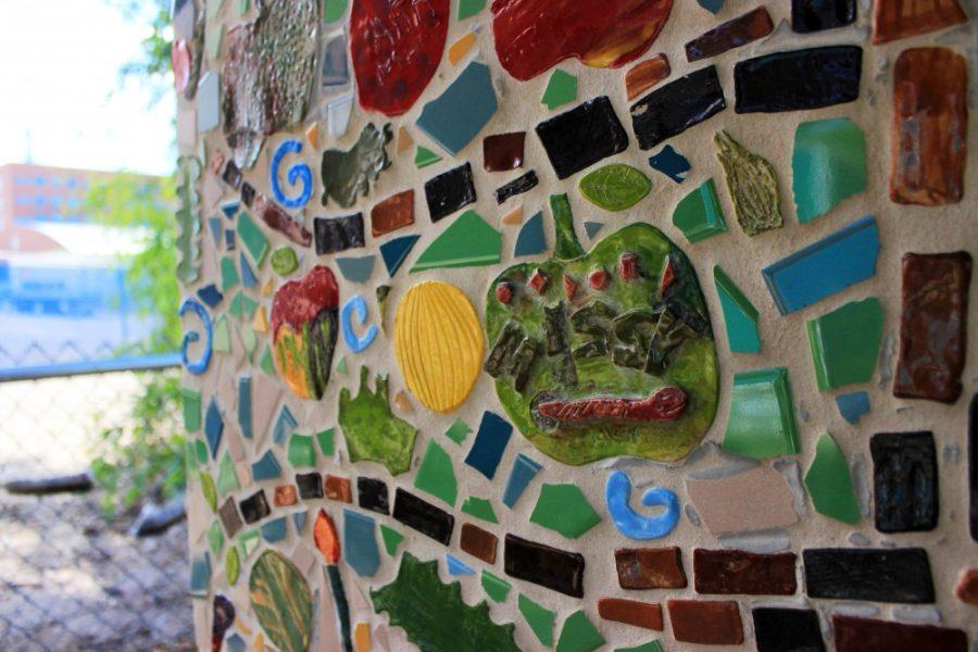 A tile mural painted by ArtWorks members decorates a pavilion at the UA community garden on Sunday, September 25, in Tucson, Ariz. Artworks provides disabled adults with the opportunity to learn artistic and life-long skills, while also giving back to the community.