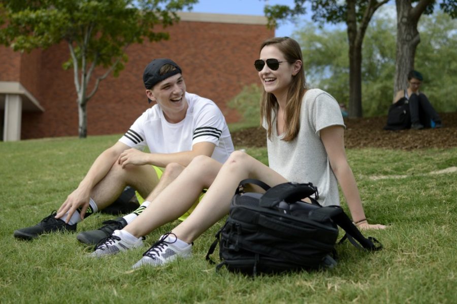 Freshman Dance Majors Keenan Schember and Hanlon Landry hangout on the grass hill near the administrative building on Wednesday afternoon. Schember and Landry say they like the atmosphere around campus so far.