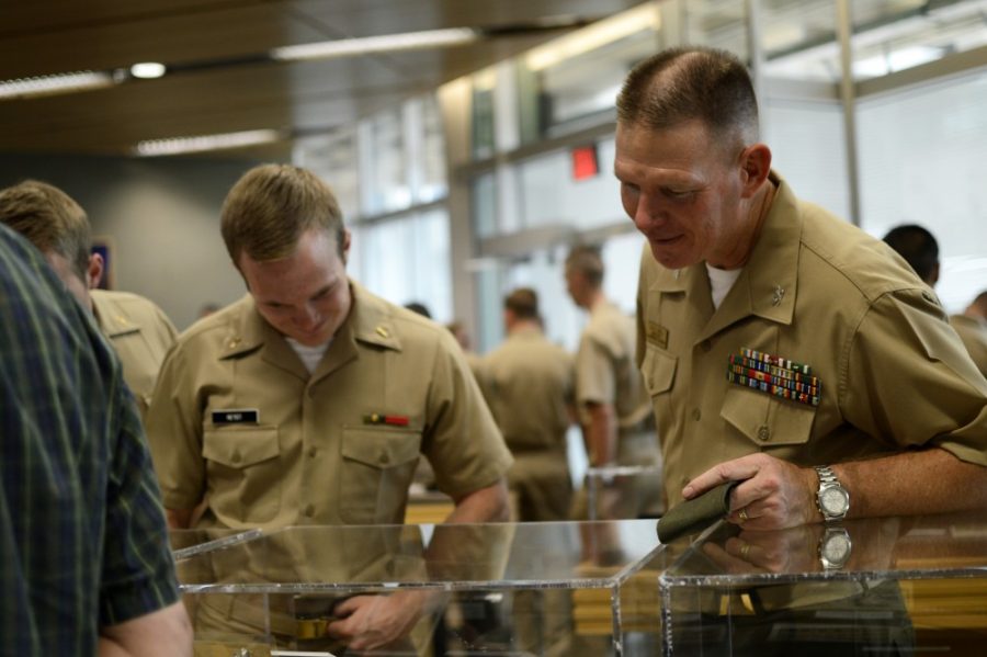 Professor of naval science and Colonel Patrick Wall, converses with ROTC member Alexander Heydt on Wednesday, Aug. 31. UAs special collections gave UA NROTC a special tour of the USS Arizona exhibit.