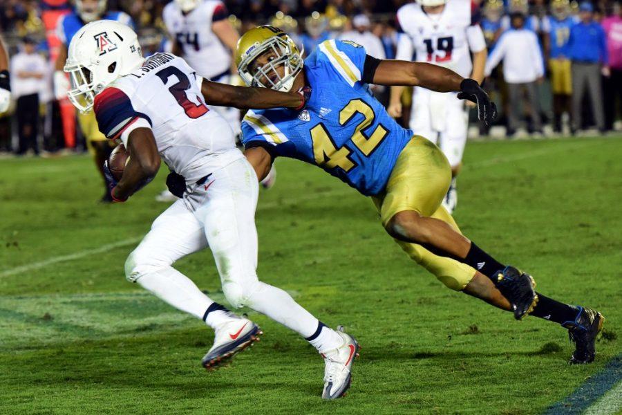 Arizona wide receiver Tyrell Johnson (2) attempts to fend off UCLA linebacker Kenny Young (42) during Arizonas 45-24 loss to UCLA at the Rose Bowl Stadium in Pasadena, Calif. on Saturday, Oct. 1, 2016.