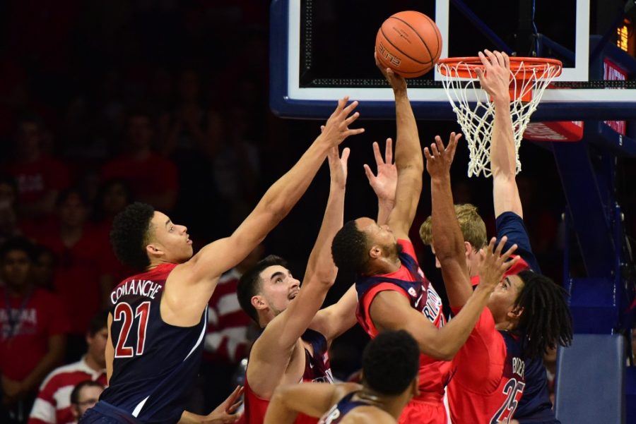 Arizona guard Parker Jackson-Cartwright tips in a basket amid heavy defense during the red and blue scrimmage at McKale Center on Friday, Oct. 14, 2016. 