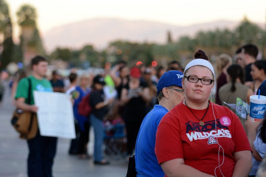 Public health freshman Hunter Homa, right, stands in a line extending hundreds of yards in preparation for the Tucson Early Vote Rally with Sen. Bernie Sanders on the UA mall on Wednesday, Oct. 18, 2016. Homa, a first time voter, said she was attending the event to become more educated about the political process.