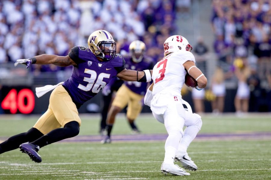 Washington linebacker Azeem Victor (36) reaches for Stanford wide receiever Michael Rector (3) during Washington’s 44-6 victory over Stanford on Friday, Sept. 30.