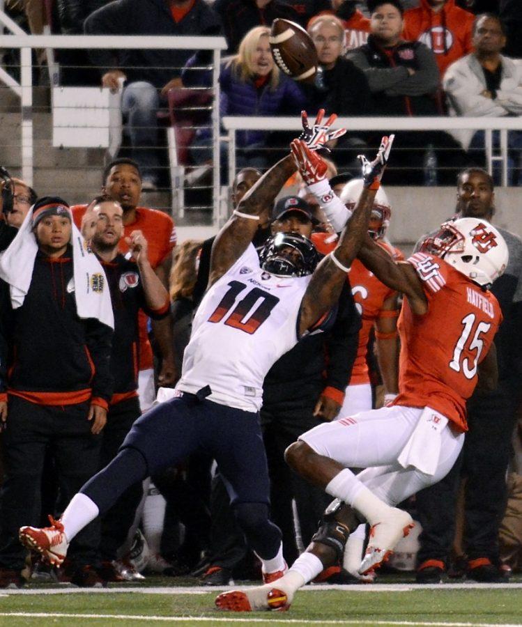 Arizona receiver Samajie Grant (10) fights Utah defensive back Dominique Hatfield (15) for a catch at Rice-Eccles Stadium in Salt Lake City, Utah on Saturday, Oct. 8. The Wildcats lost to the Utes 23-36.