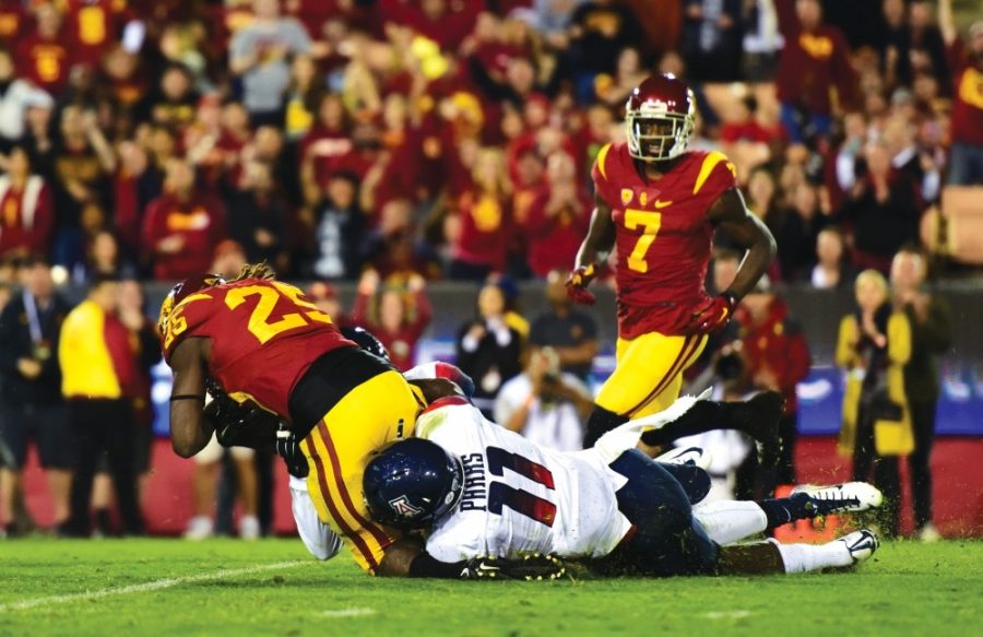 Arizona safety Will Parks (11) takes down USC tailback Ronald Jones II (25) at Los Angeles Memorial Coliseum on Nov. 7, 2015. The Wildcats face USC this Saturday looking to snap a three-game losing streak.