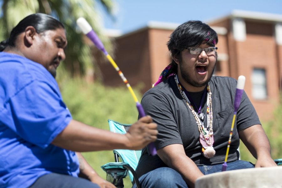 Adrian Sabori (right) sings while performing with the Starpoint Drum Group at a #NoDAPL solidarity rally on the UA Mall on Thursday, Sept. 15, 2016. The demonstration supports the Standing Rock Sioux tribe, which is protesting the construction of the Dakota Access pipeline that would pass under the Missouri river just outside the tribal boundary.