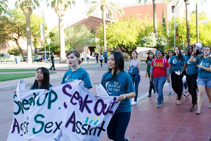 UA students walk with a sign reading Speak Up. Speak Out. Against Sexual Assault. in the Take Back the Night March on Tuesday, April 12. The Dean of Students Office, Womens Resource Center and Students Promoting Empowerment and Consent are hosting the Fearless Conference, a free one-day conference to empower the movement to end sexual violence.