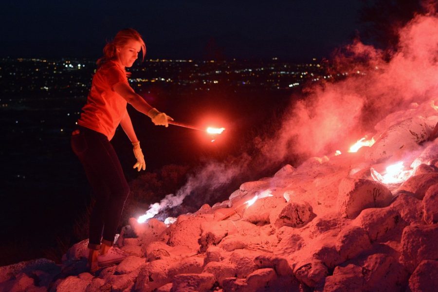 Emily Sill, an elementary education senior and member of the Bobcat senior honorary, checks for more flares to light on A Mountain on Sunday, Oct. 23, 2016. The lighting of the A by the Bobcats is a tradition kicking off the week of Homecoming each year.