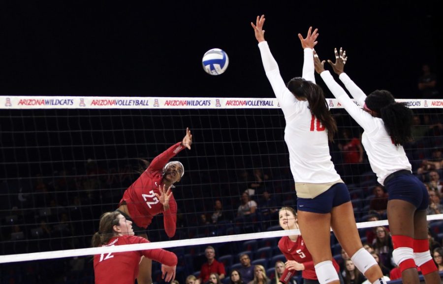 Arizona outside hitter Kalei Mau (left) and middle blocker (right) Devyn Cross block a hit from outside hitter Kyra Holt (22) in Fridays game against Washington State. Mau expressed her body is not fully healthy yet as the Wildcats lost in straight sets to Washington State.