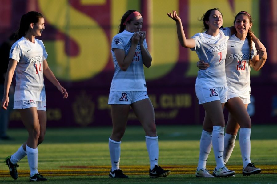 Arizona defender Brynn Moga (7) celebrates her teammate Samantha Falasco (23)s first goal as a Wildcat with an embrace after the Wildcats 1-0 win over ASU at Sun Devil Soccer Stadium in Tempe on Friday, Nov. 4, 2016. Falasco left the match during the first half after a collision with ASU forward Larisa Staub (23), but later returned to score the only goal of the game.