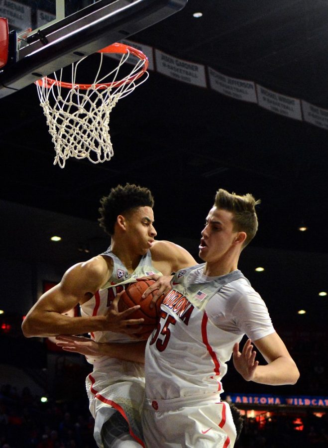 Arizona center Chance Comanche (21) collides with Jake Desjardins (55) after recovering a rebound against Sacred Heart in McKale Center on Friday, Nov. 18. The Wildcats beat the Pioneers 95-65.