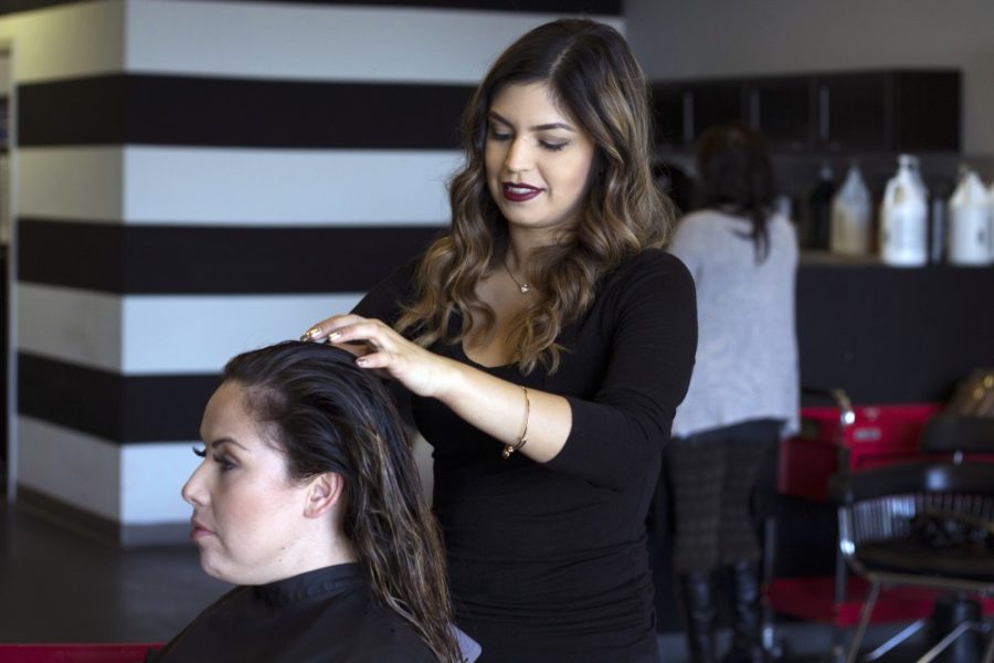 Nicole Cruz, hairstylist of over three years, works with a client of hers Wednesday, Nov. 23 at Ella6 Salon. The Ella6 Studio is a full-service Paul Mitchell-focused salon that was founded in 2013.