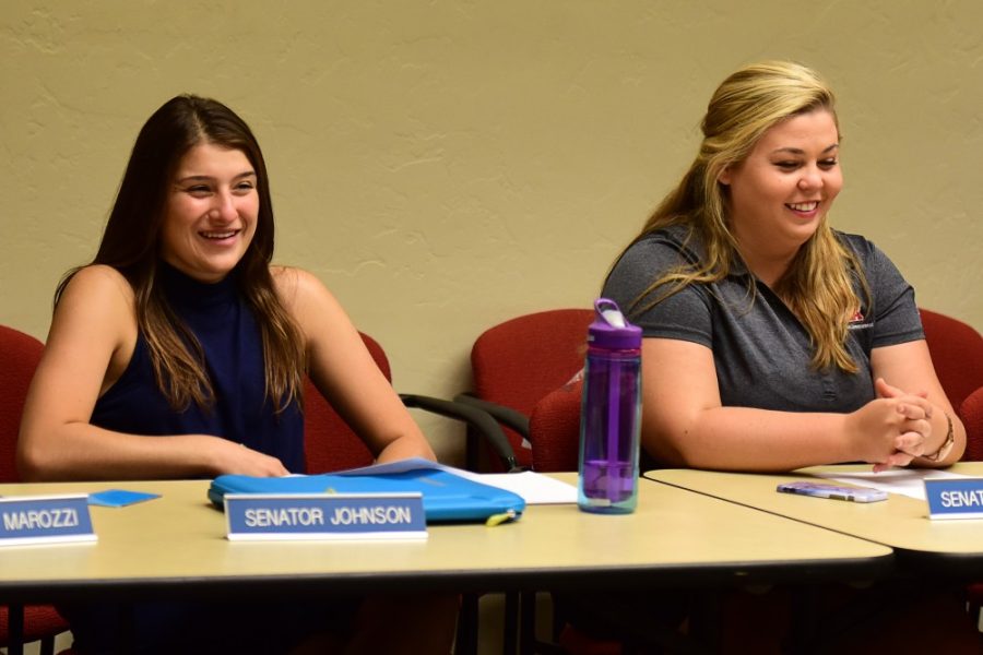 ASUA Sen. Olivia Johnson and Sen. Emily Hastings smile during an ASUA meeting in the Student Union Memorial Center on Wednesday, Aug. 24, 2016. 