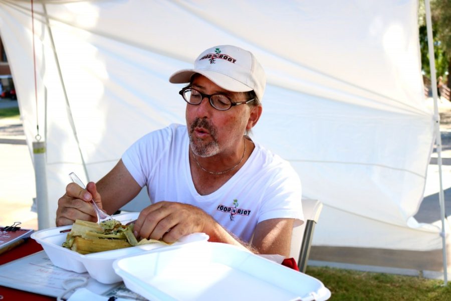 Mike Rosenkrantz, the market manager for farmers markets around Tucson, enjoys a vegetarian tamale from Del Cielo Tamales on Wednesday, Nov. 2.