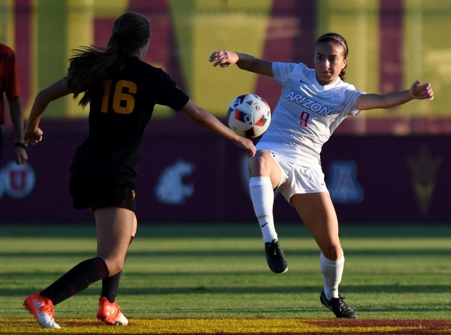 Arizona midfielder Gabi Stoian (9) kicks it away from ASU defender Madison Wolf (16) at Sun Devil Soccer Stadium in Tempe on Friday, Nov. 4, 2016. The Wildcats shut out the Sun Devils 1-0 for their first Territorial Cup win in soccer since 2013.