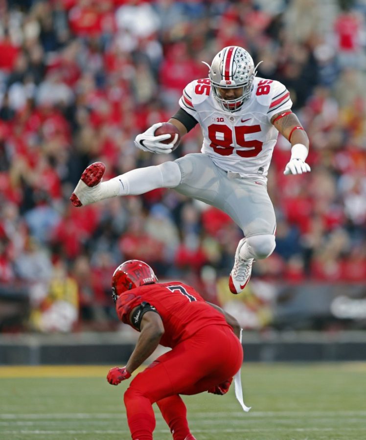 Ohio State tight end Marcus Baugh (85) leaps over Maryland Terrapins back JC Jackson (7) after making a catch during the first half at Maryland Stadium in College Park, Md., on Saturday, Nov. 12, 2016. (Kyle Robertson/Columbus Dispatch/TNS) 