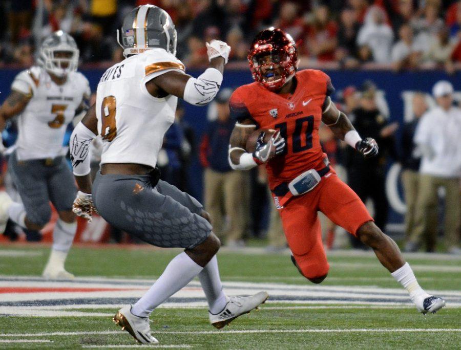 Arizona running back Samajie Grant (10) keeps an eye on the Arizona State defense as he rushes during the 2016 Territorial Cup at Arizona Stadium on Friday, Nov. 25. The Wildcats took home the Territorial Cup after triumphing over the Sun Devils 56-35.