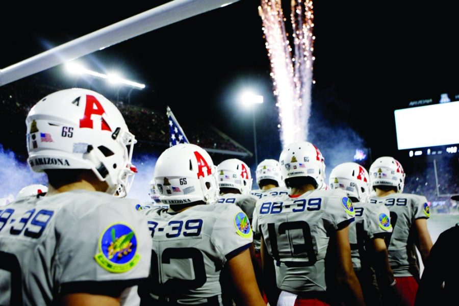 The Arizona football team enters their field decked out in their USS Arizona commemorative uniforms before their 48-27 win against Hawaii on Saturday, Sept. 17 at Arizona Stadium.