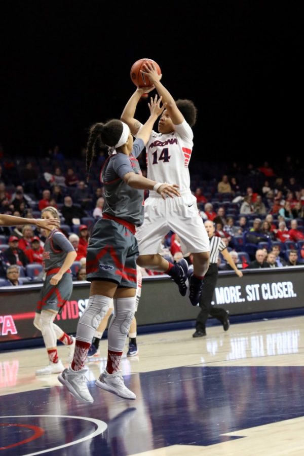Arizona guard Malena Washington springs up to shoot past a Flordia Atlantic defender on Thursday, Dec. 1 in McKale Center. The Wildcats are down 38-39 at the half.
