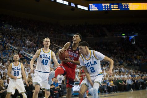 UA's Allonzo Trier readies a shot amidst UCLA defense, during the UA-UCLA game on Jan. 21. 