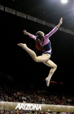 Arizona gymnast Shelby Edwards leaps above the beam in McKale Memorial Center on Saturday, Feb. 27, 2016.