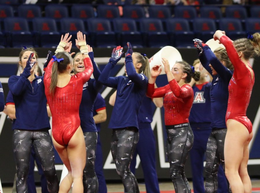 The+UA+Womens+Gymnastics+team+celebrates+after+their+win+over+Iowa+State+on+Jan.+21.