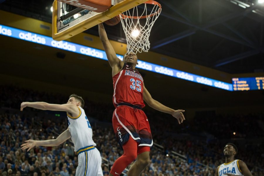 Allonxo Trier (35) dunks over UCLA defense in his return to playing for the UA Wildcats.