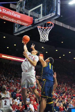 Arizona's Chance Comanche (21) attempts to dunk the ball while being blocked by California's Ivan Rabb (1) during the Men's Basketball game on Feb. 11.