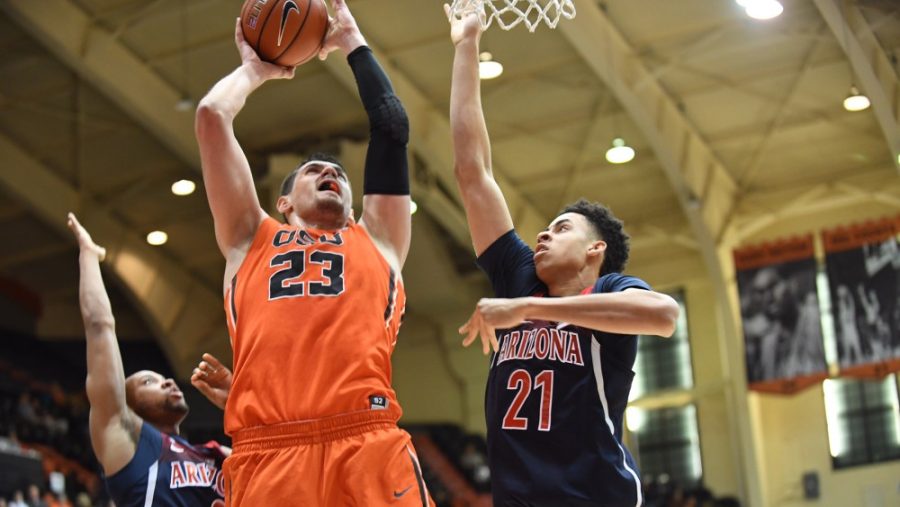 Arizona player Chance Comanche (21) attempts to defend a lay-up from Oregon States Gligorije Rakocevic (23) in the Gill Coliseum on Feb. 2.